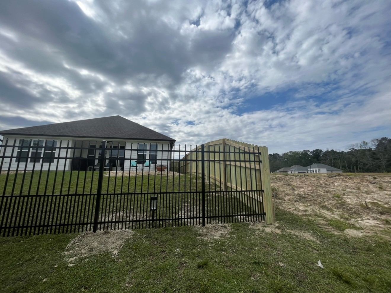 Black aluminum panel fence installation