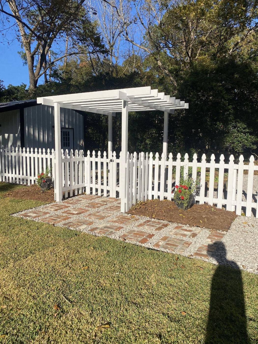 White picket wood fence with pergola gate