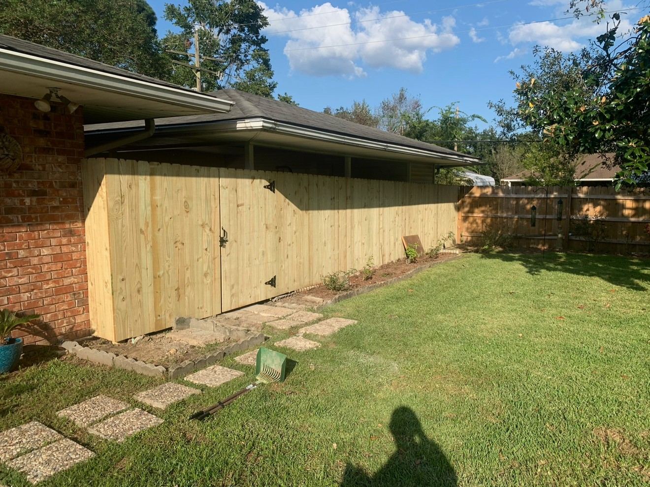 Wood privacy fence with storage door