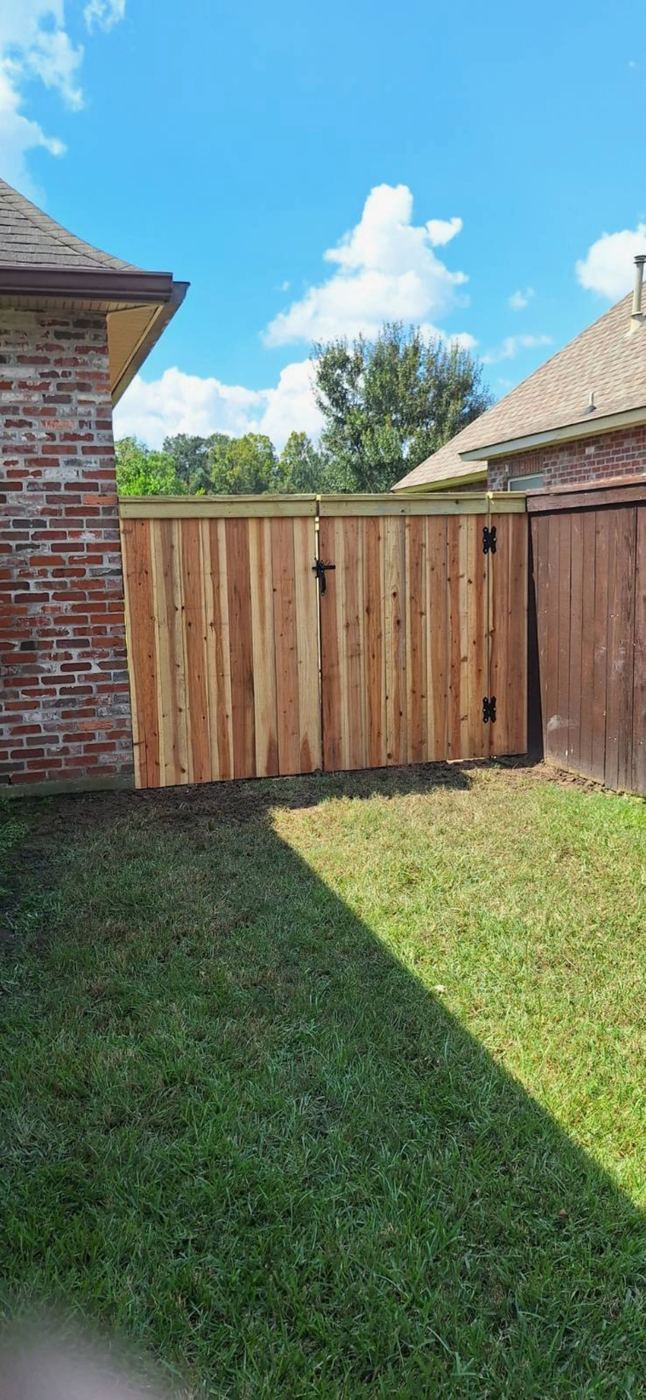 Wood gate tied into two fence styles