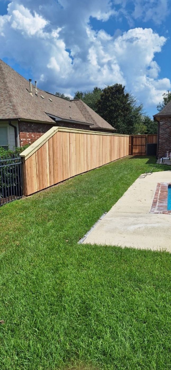 Wood privacy fence with gate near pool
