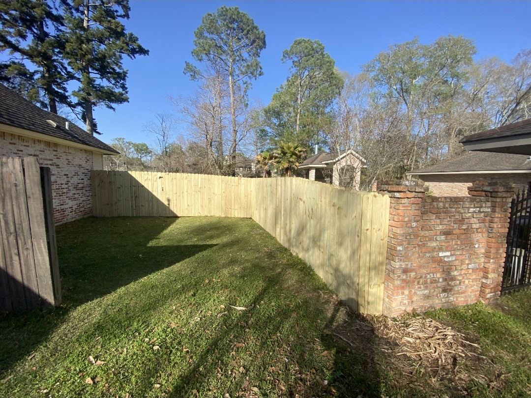 Wood fence tied into an existing brick column