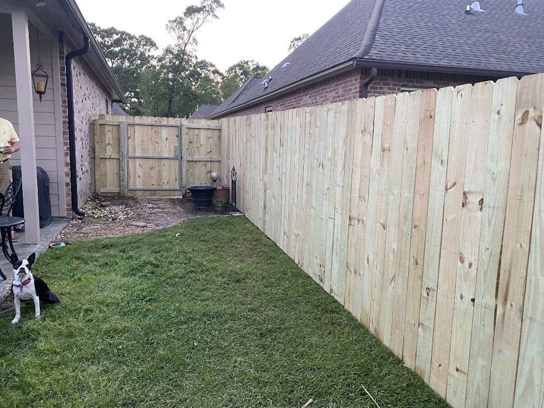 Wood privacy fence with double drive gate