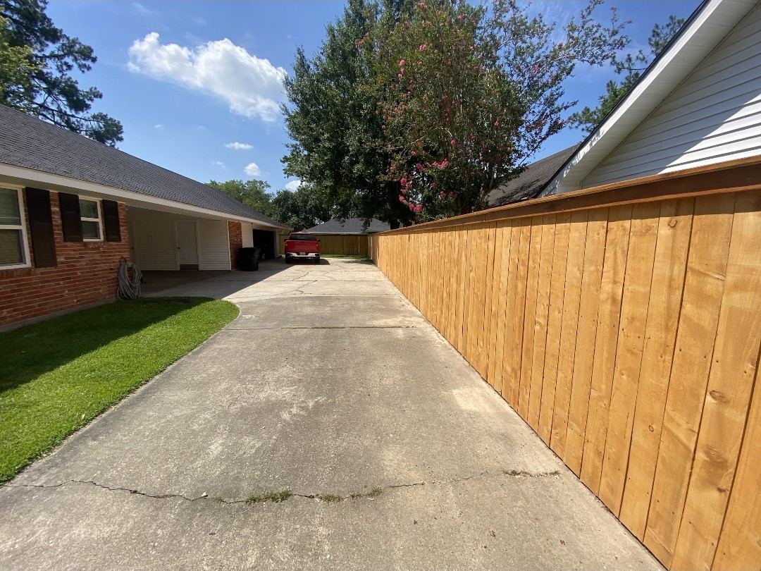 Wood privacy fence along driveway