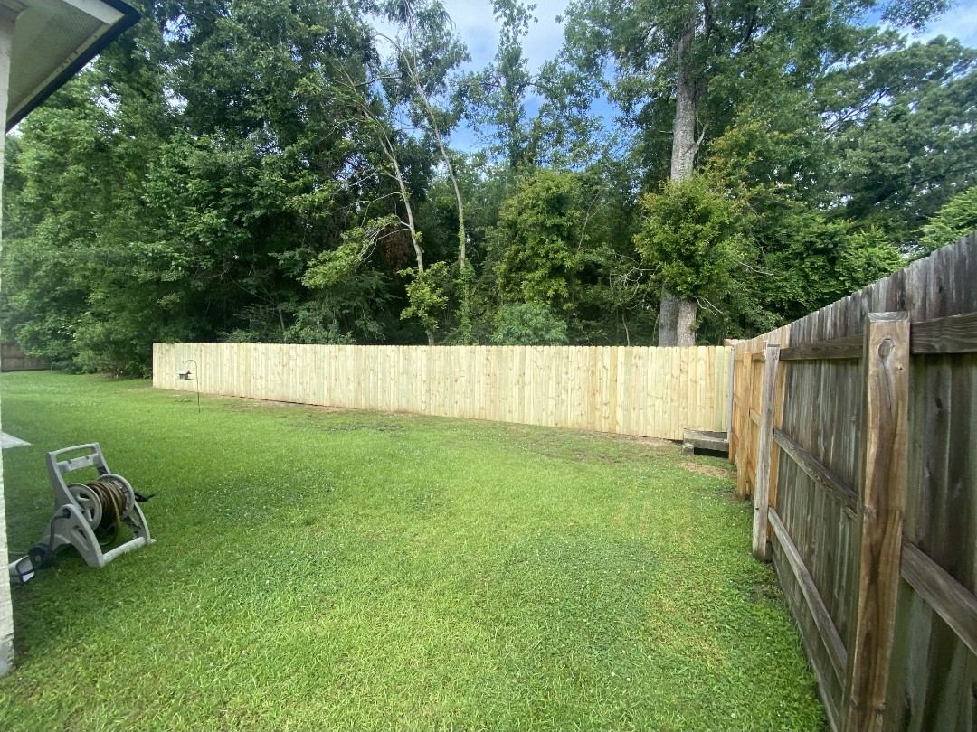 New wood fence tied into existing fence line